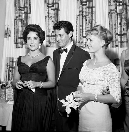 Singer Eddie Fisher poses with his wife Debbie Reynolds and friend Elizabeth Taylor at the Tropicana Hotel in Las Vegas in this publicity photograph