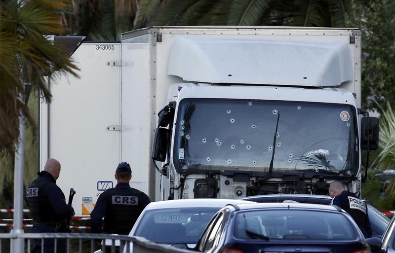 French CRS and judicial police work near the heavy truck that ran into a crowd at high speed celebrating the Bastille Day July 14 national holiday on the Promenade des Anglais killing 80 people in Nice