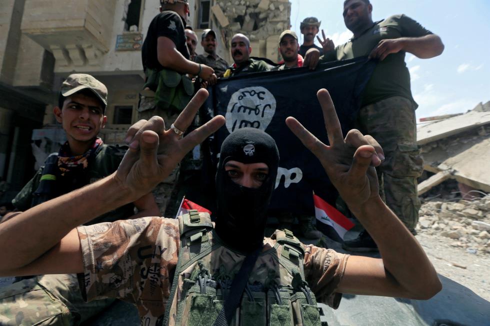 Members of the Emergency Response Division celebrate in the Old City of Mosul