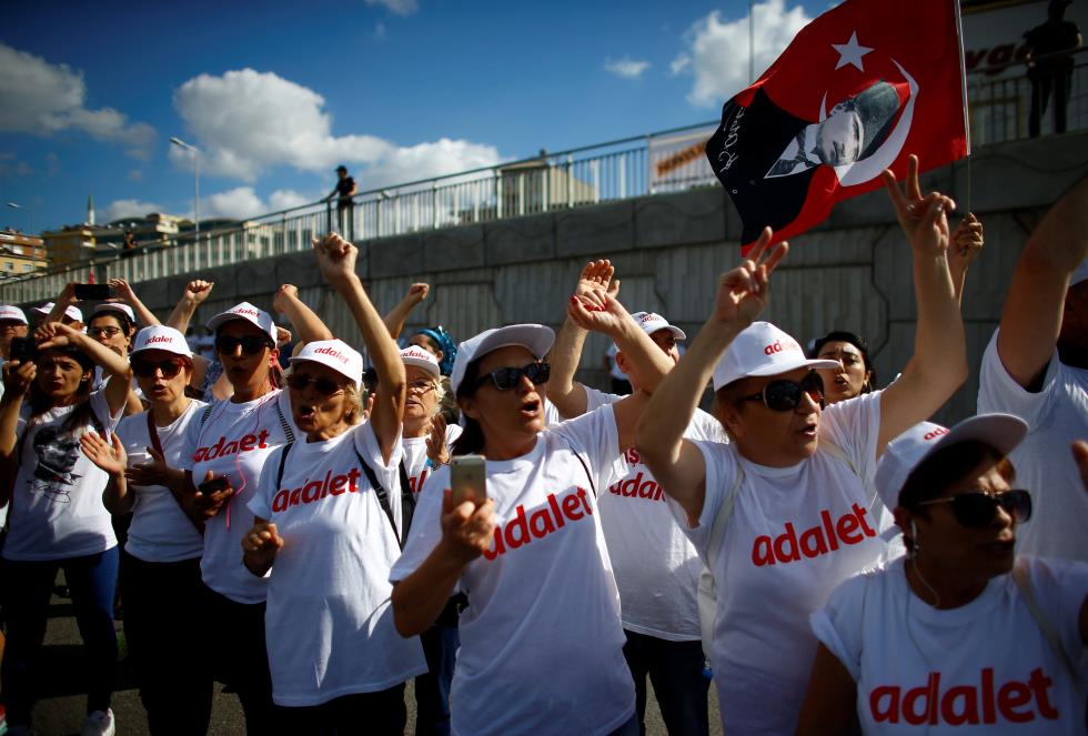 Supporters of Turkeys main opposition leader Kilicdaroglu shout slogans as he walks during the 24th day of a protest, dubbed "justice march" in Istanbul