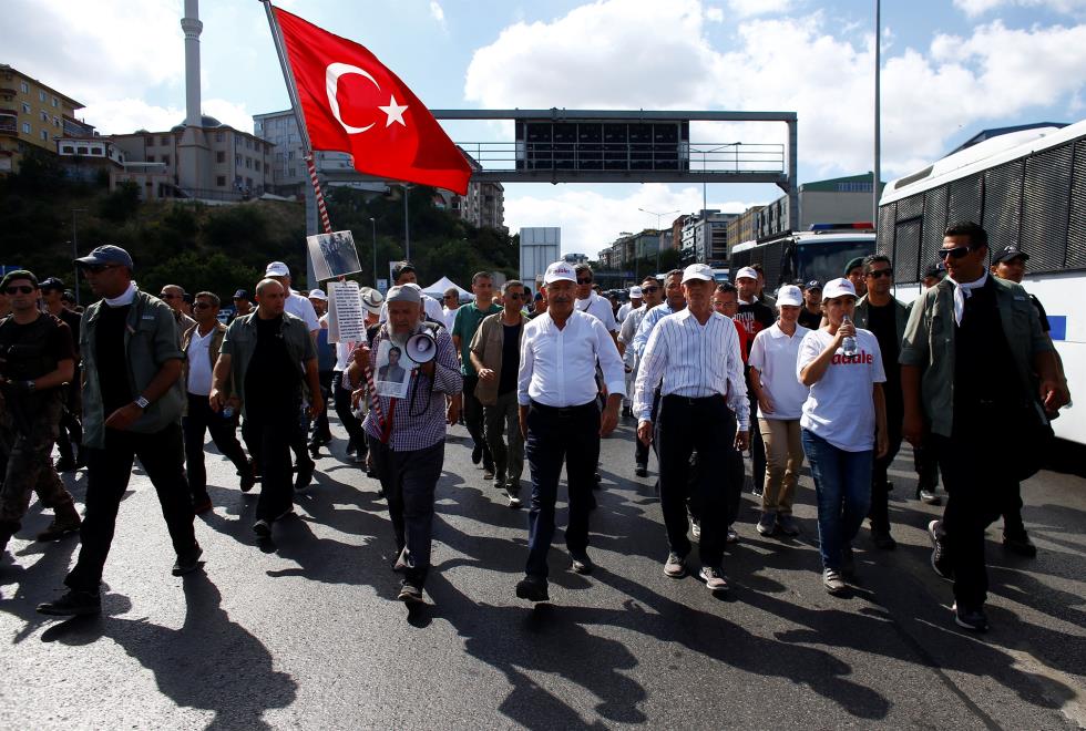 Turkeys main opposition leader Kilicdaroglu walks flanked by his supporters during the 24th day of a protest, dubbed "justice march" in Istanbul