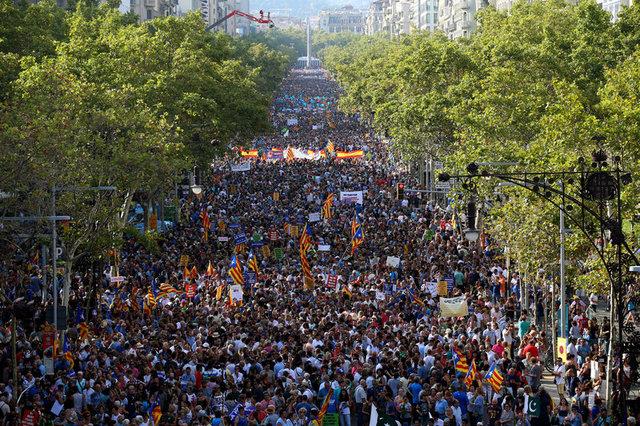 People hold placards and flags as they take part in a march of unity after the attacks last week, in Barcelona, Spain