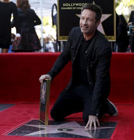 Actor Duchovny touches his star after it was unveiled on the Hollywood Walk of Fame in Los Angeles