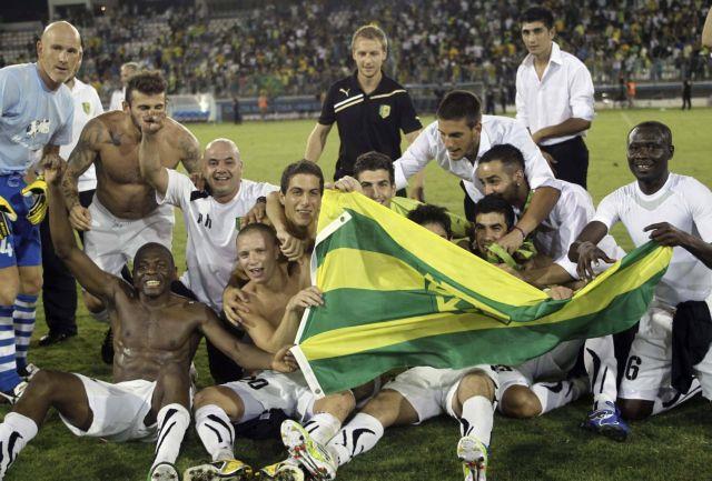 AEK Larnaca players celebrate at the end of their Europa League second leg playoff soccer match against Rosenborg in Larnaca