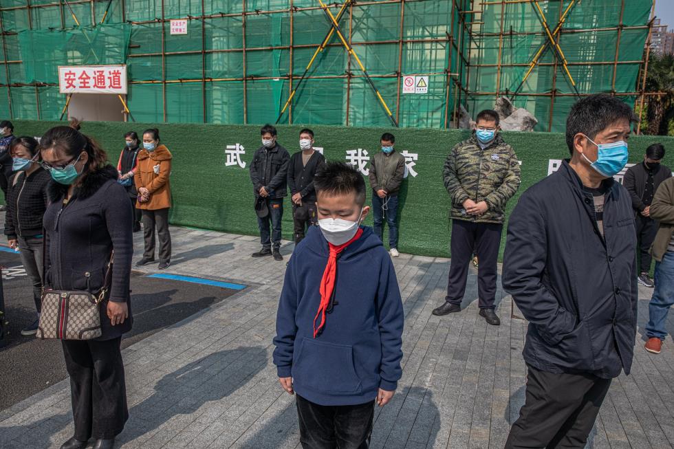 People observe three minutes of silence for victims of COVID-19, in China