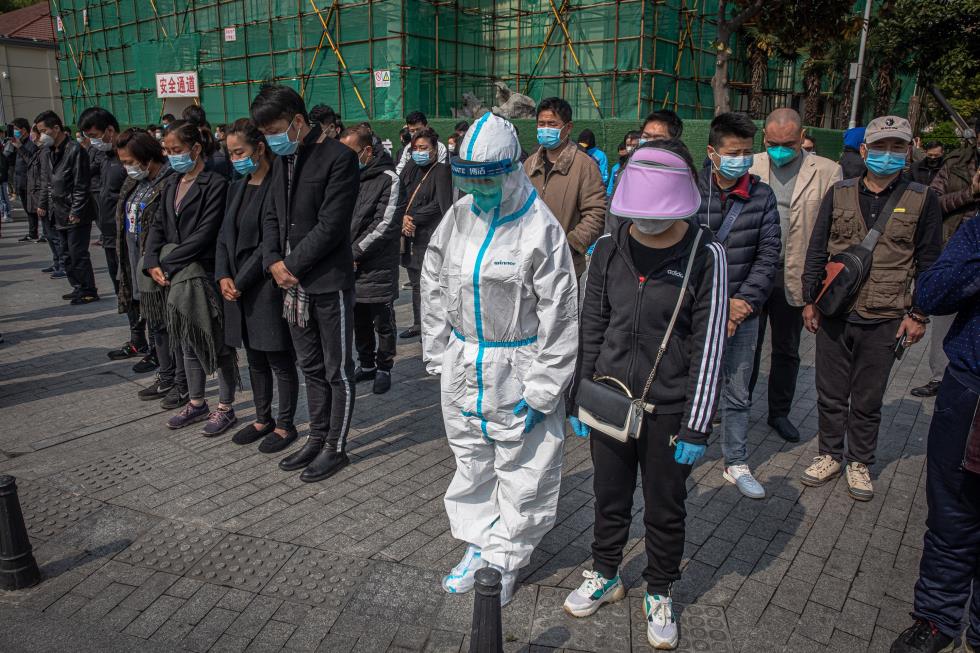 People observe three minutes of silence for victims of COVID-19, in China