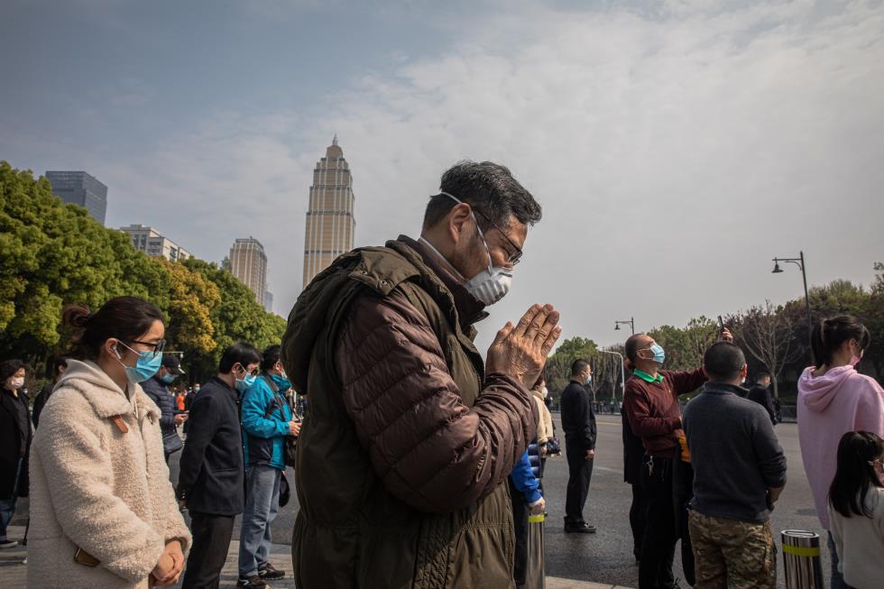 People observe three minutes of silence for victims of COVID-19, in China