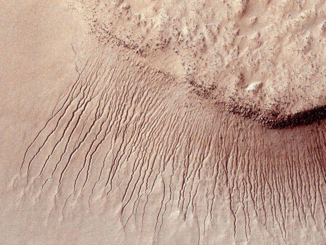 Portions of the Martian surface are pictured from NASAs Mars Reconnaissance Orbiter